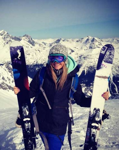 A Female Luxury Skier Holding Her Gear