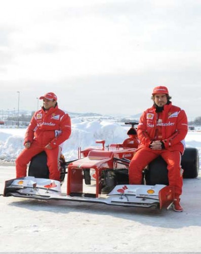Two Formula One Drivers Sitting On Ferrari F2012 Tires